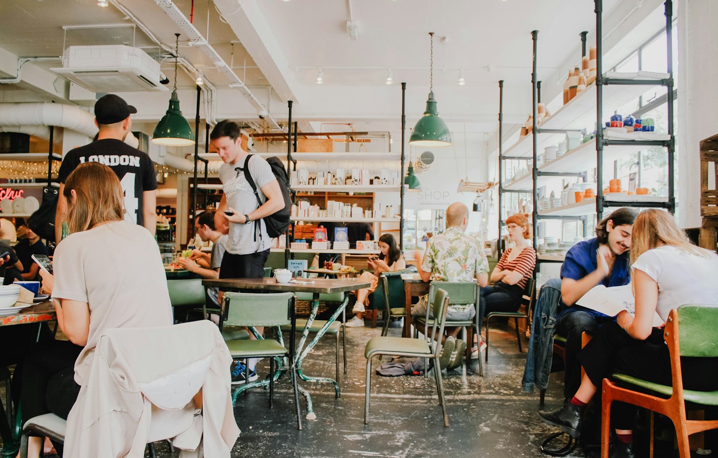 A busy neighborhood café full of customers