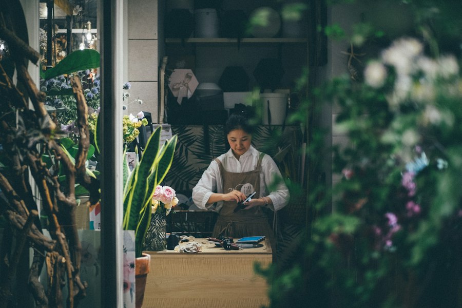 A florist working in a plant-filled shop