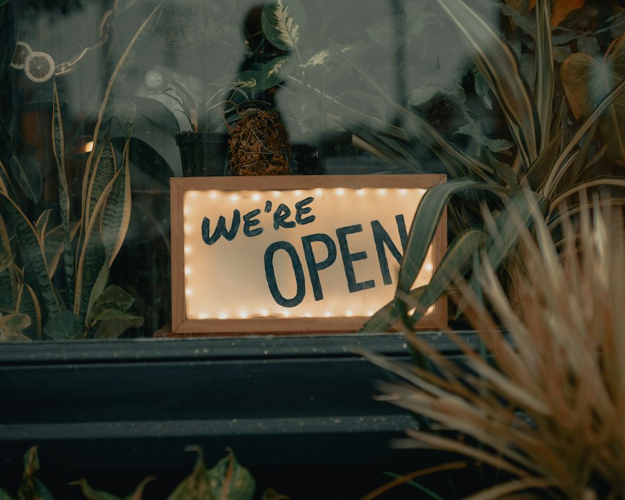 A glowing “We’re open” sign in a shop window