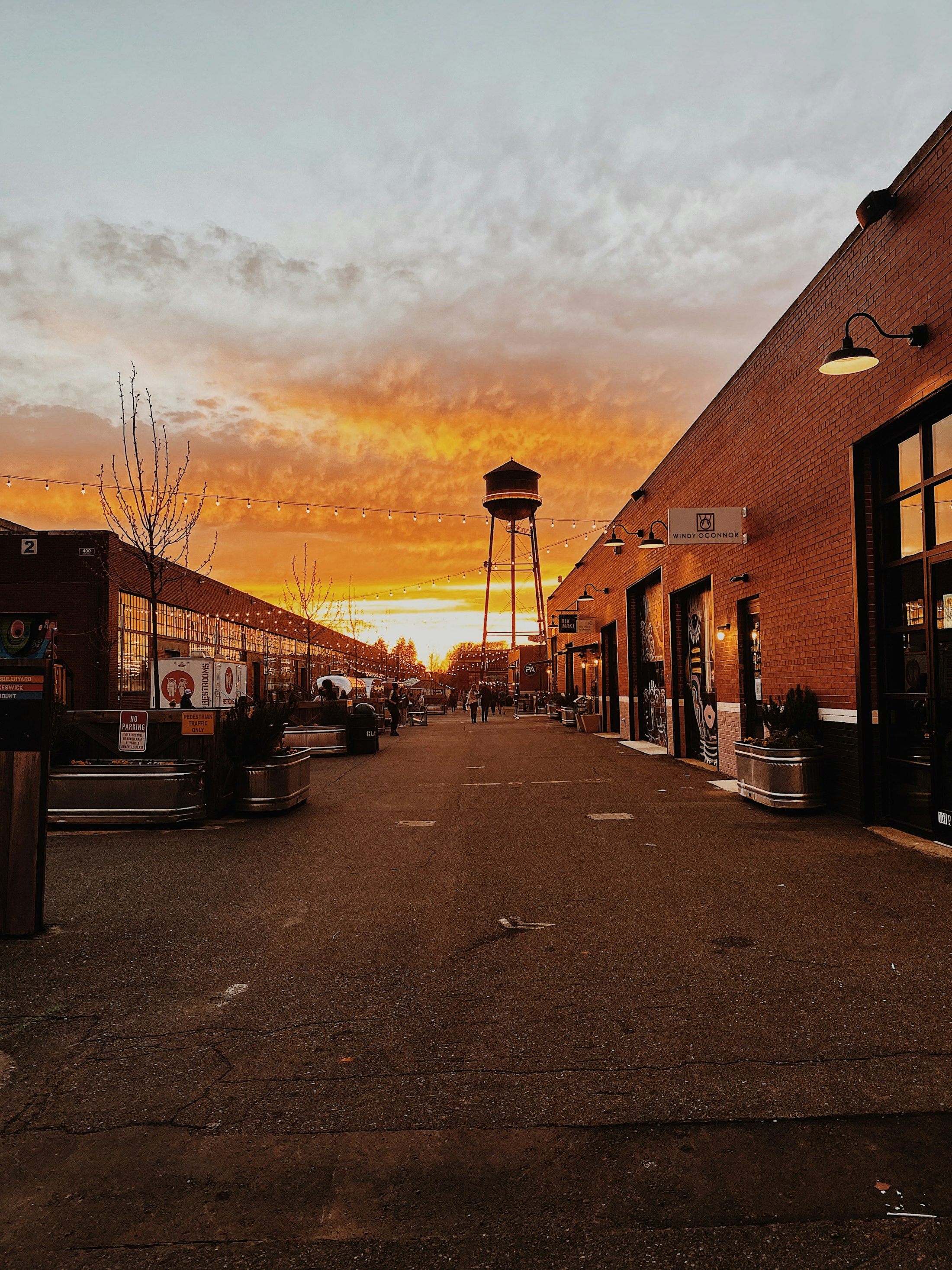 A quiet main street of shops at sunset